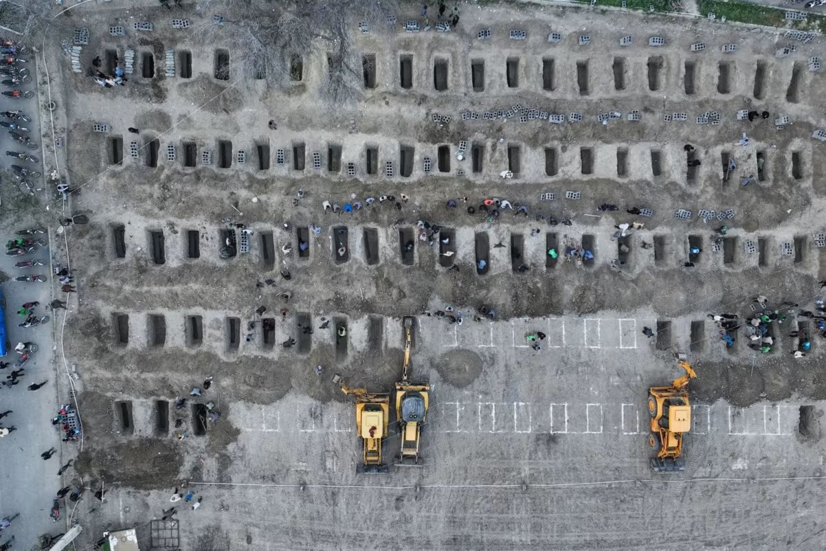 Mourners dig graves on Tuesday for those killed in a February 28 strike on the Shajare Tayyiba elementary school in Minab, Iran. Iranian Press Center - AFP Getty Images